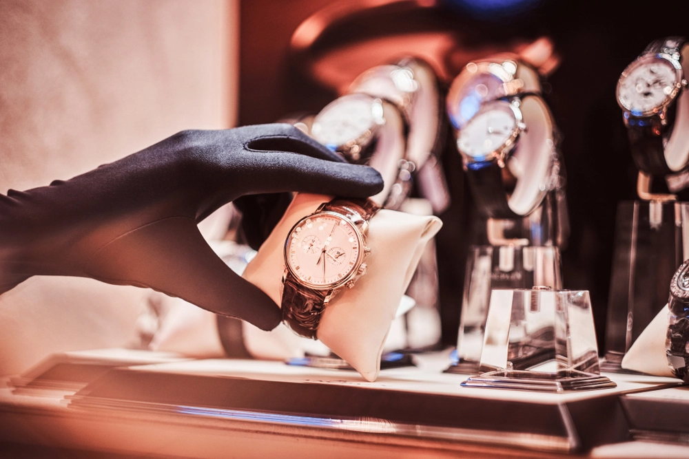Seller's hand in gloves shows the exclusive watch.
