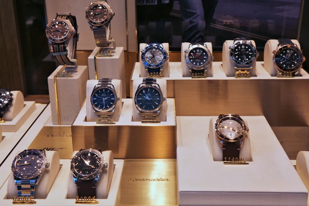 Omega brand wrist watches on display in a jewelry store.